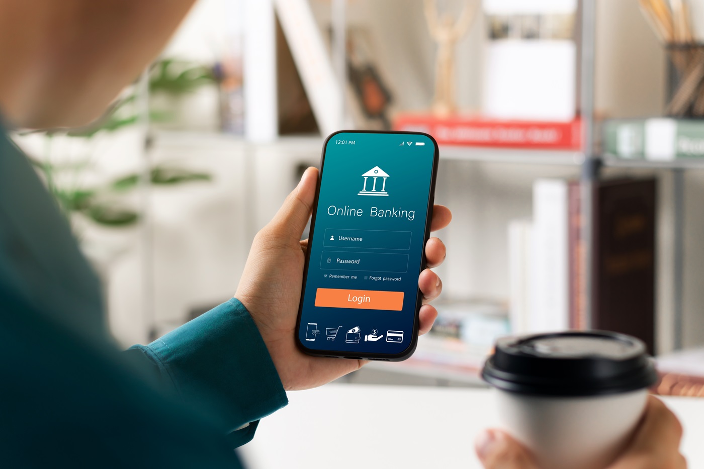 person holds smartphone with mobile banking app on the screen