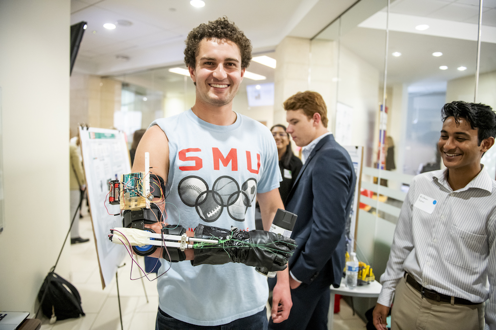 SMU undergraduate researchers exhibit a project during an on-campus symposium