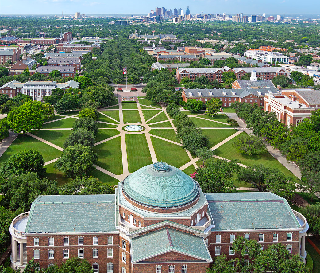 Drone-captured flyover image of the SMU campus, know as The Hilltop. The Dallas city skyline is located just south of the campus.