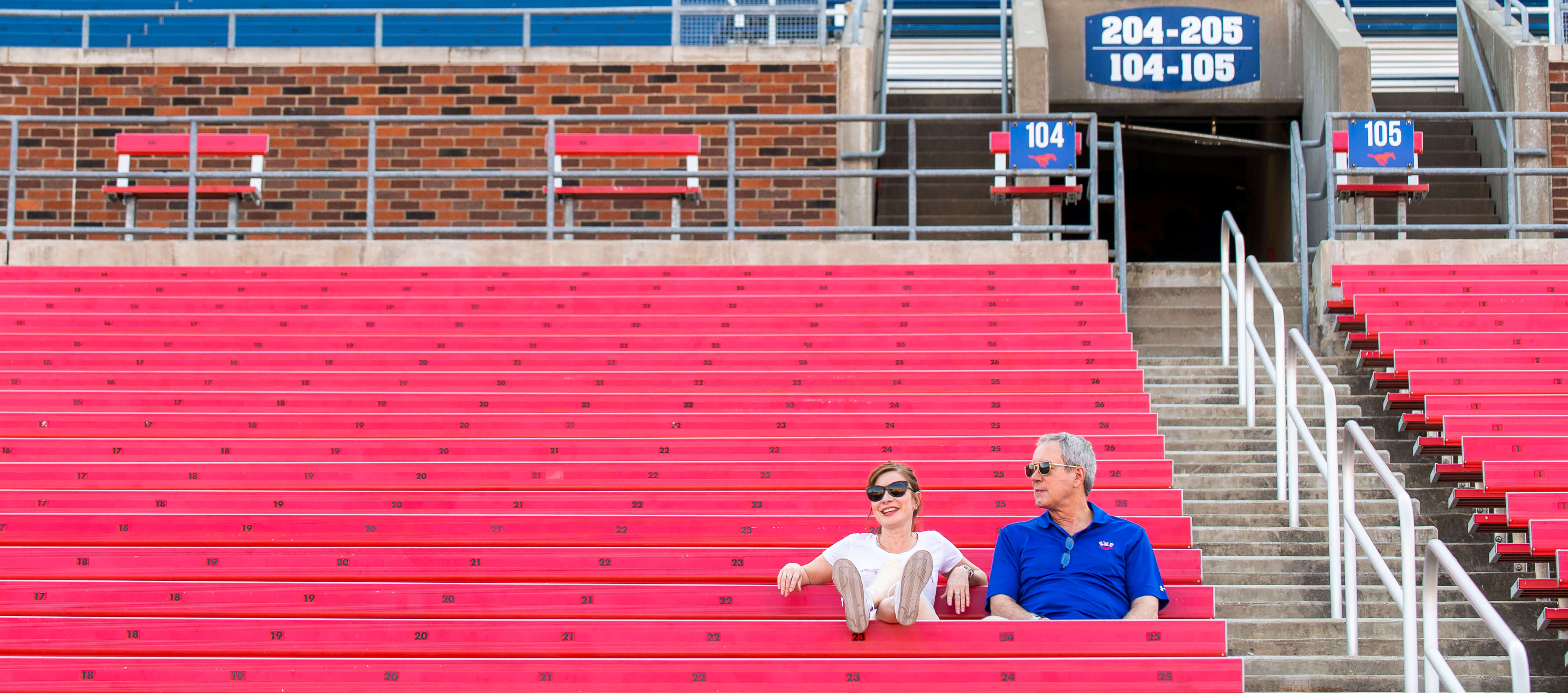Alumni seated in Ford Stadium stands during an SMU event